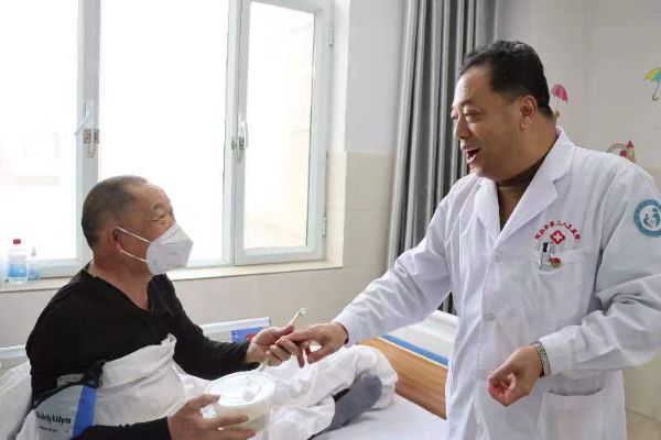 图为十二团医院安卫民院长用微笑服务患者，同患者拉家常、嘘寒问暖，让患者舒心。.jpg