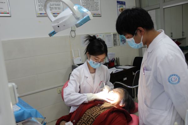 图为十二团医院口腔科大夫为患者服务。.JPG